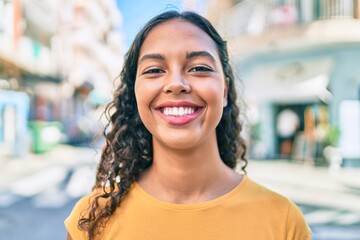 Young african american girl smiling happy walking at city.
