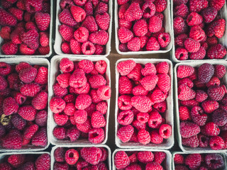 raspberries for sale in baskets, Wooden baskets with ripe raspberries on the counter of a street shop.
