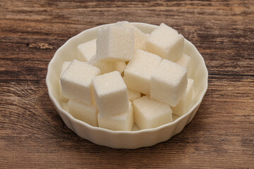 Refined white sugar cubs in the bowl
