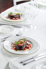 Half baked eggplants with meat, cheese and tomatoes on white background. Banquet festive dishes. Gourmet restaurant menu. White background.