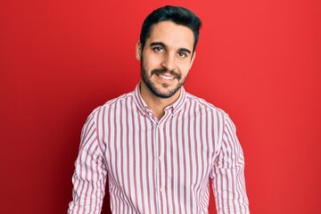 Young hispanic man wearing business shirt with a happy and cool smile on face. lucky person.