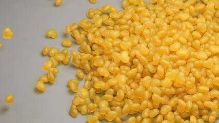 Yellow caramel hearts on gray background 