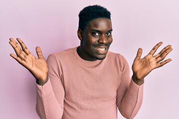 Fototapeta premium Handsome black man wearing casual clothes celebrating victory with happy smile and winner expression with raised hands