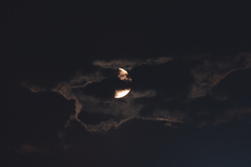The moon among the stars and clouds