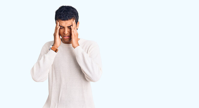 Young african amercian man wearing casual clothes with hand on head, headache because stress. suffering migraine.