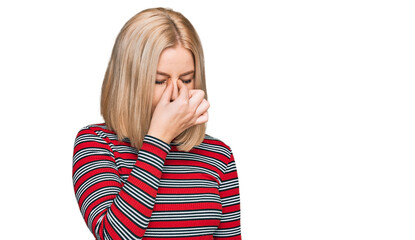 Young blonde woman wearing casual clothes tired rubbing nose and eyes feeling fatigue and headache. stress and frustration concept.