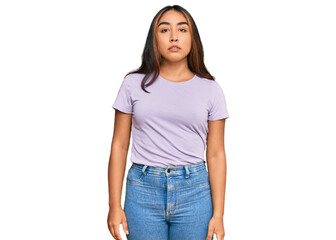 Young latin woman wearing casual clothes relaxed with serious expression on face. simple and...