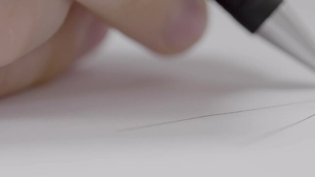 Extreme close-up shot of a hand drawing a technical draft. The camera passes the hand in a straight line with the focus shifting continuously.