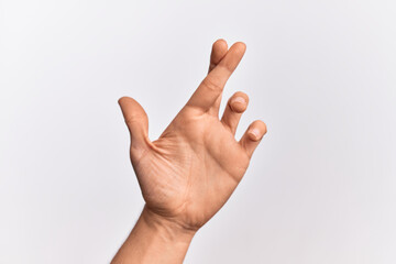 Hand of caucasian young man showing fingers over isolated white background gesturing fingers crossed, superstition and lucky gesture, lucky and hope expression