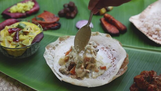 Appam with mutton stew Non-vegetarian sadhya Indian food for Onam sadya Christmas Easter celebration Kerala India Sri Lanka 4K slow motion video footage hoppers beef fry fish curry rice on banana leaf