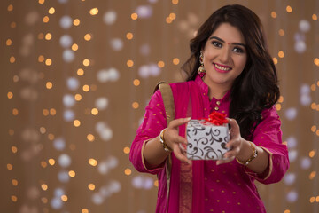 Naklejka premium woman smiling and offering gift. 