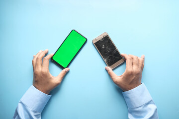 Close up of man hand holding smart phone broken display 