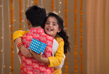 brother and sister hugging each other	