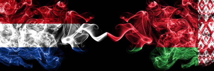 Netherlands vs Belarus, Belarusian smoky mystic flags placed side by side. Thick colored silky abstract smoke flags.