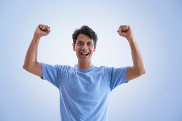 young man clenching fists and cheering	