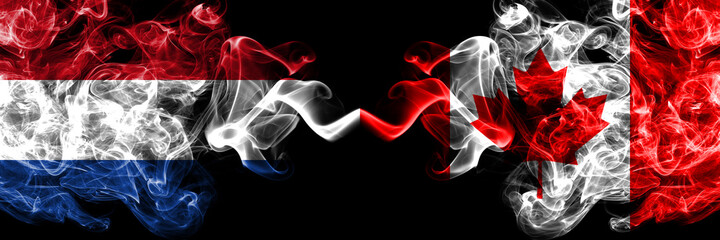 Netherlands vs Canada, Canadian smoky mystic flags placed side by side. Thick colored silky abstract smoke flags.