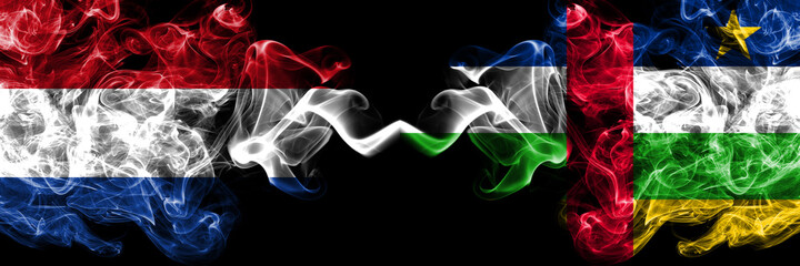 Netherlands vs Central African Republic smoky mystic flags placed side by side. Thick colored silky abstract smoke flags.
