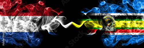 Netherlands vs East African Community smoky mystic flags placed side by side. Thick colored silky abstract smoke flags.