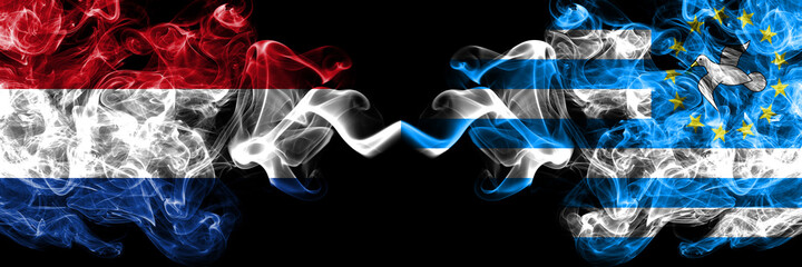 Netherlands vs Federal Republic of Southern Cameroons smoky mystic flags placed side by side. Thick colored silky abstract smoke flags.