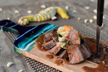 grilled steak chops on an wooden board 