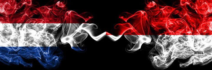 Netherlands vs Indonesia, Indonesian smoky mystic flags placed side by side. Thick colored silky abstract smoke flags.