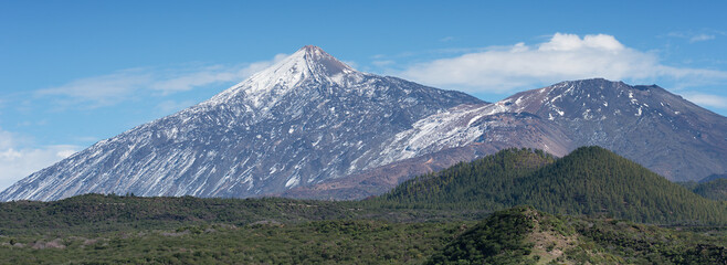 Pico del Teide mountain volcano in snow, bright blue sky. Teide National Park, Tenerife, Canary...