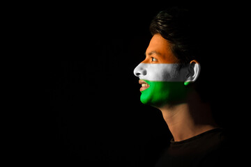 man smiling with tricolour painted on his face, independence day	