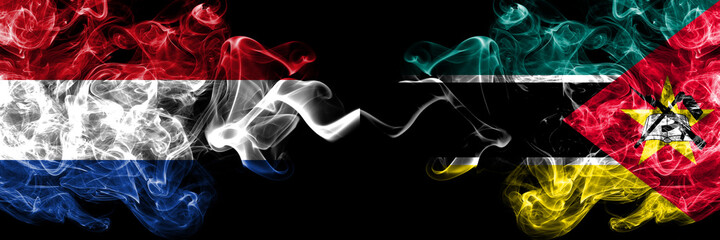 Netherlands vs Mozambique, Mozambican smoky mystic flags placed side by side. Thick colored silky abstract smoke flags.