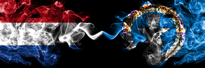 Netherlands vs Northern Mariana Islands smoky mystic flags placed side by side. Thick colored silky abstract smoke flags.