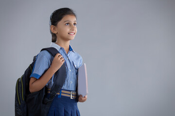 portrait of a school girl holding bag and books   © IndiaPix