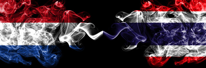 Netherlands vs Thailand, Thai smoky mystic flags placed side by side. Thick colored silky abstract smoke flags.