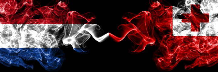 Netherlands vs Tonga smoky mystic flags placed side by side. Thick colored silky abstract smoke flags.