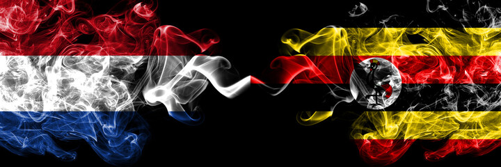 Netherlands vs Uganda smoky mystic flags placed side by side. Thick colored silky abstract smoke flags.