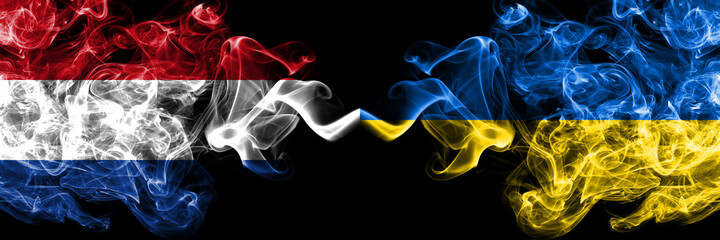 Netherlands vs Ukraine, Ukrainian smoky mystic flags placed side by side. Thick colored silky abstract smoke flags.