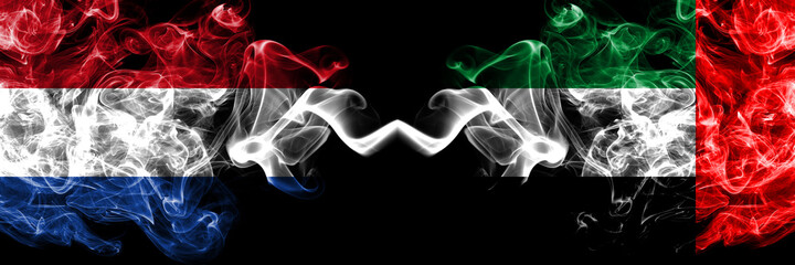Netherlands vs United Arab Emirates, Emirati smoky mystic flags placed side by side. Thick colored silky abstract smoke flags.