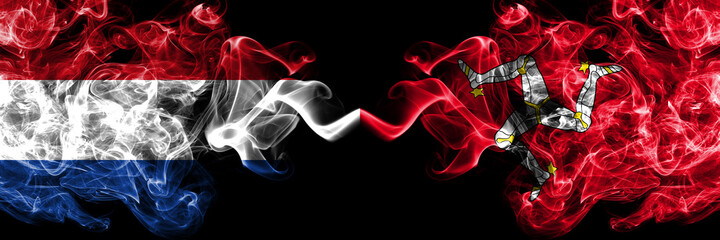 Netherlands vs United Kingdom, Great Britain, British, Isle of Mann  smoky mystic flags placed side by side. Thick colored silky abstract smoke flags.