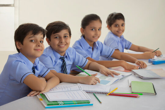 children studying in class and smiling	