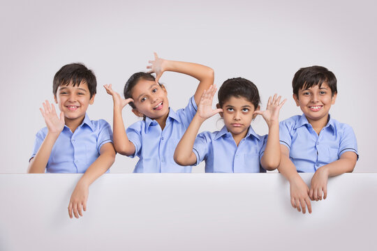 portrait of school children standing and teasing	