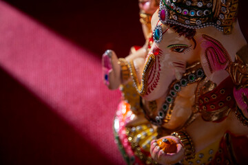 ganesh idol with flower petals	