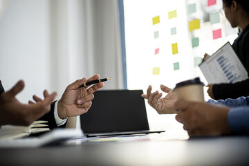 The atmosphere in the meeting room where businessmen and business partners are meeting together, meeting summaries and brainstorming to make the company grow more. Concept of business administration.