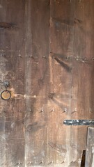 A firmly closed door with the traditional feel of rough wood