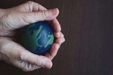 Earth Day. Male hand holding earth in his hands. Human saving planet earth. There is no planet b concept. Earth day concept. Protecting the world is in our hands