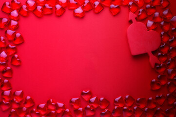 frame of red glass hearts on a red background, place for text