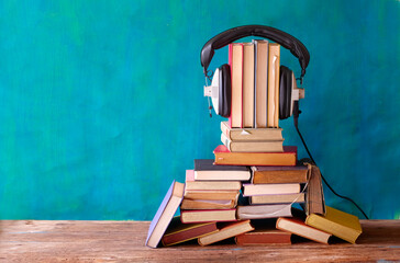 audio book concept with large heap of books and vintage...