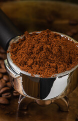 Preparing espresso, macro of portafilter with ground coffee