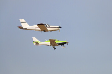 Airshow, sports ultralight planes in the sky perform a stunt