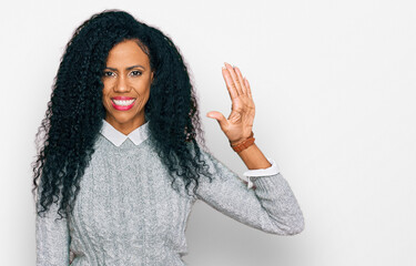 Middle age african american woman wearing casual clothes showing and pointing up with fingers number five while smiling confident and happy.