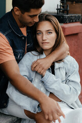 Stylish young couple hugging. Man and woman wearing jeans jacket and embracing. Couple in love in the city. Urban lovestory