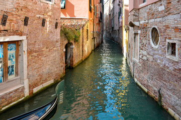 Small narrow canal between buildings in Venice in Italy