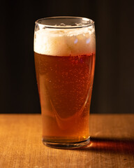 A glass of delicious craft beer served on an authentic beer glass, to be used as a background.